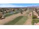 Scenic community aerial view with a golf course winding through well-manicured lawns and ponds at 7405 N Via Camello Del Norte -- # 137, Scottsdale, AZ 85258