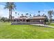 Inviting community entrance with lush landscaping and the 'CAMELOT CLUB' sign at 7405 N Via Camello Del Norte -- # 137, Scottsdale, AZ 85258
