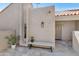 Inviting courtyard entrance featuring textured walls, charming bench, and well-manicured potted plants at 7405 N Via Camello Del Norte -- # 137, Scottsdale, AZ 85258