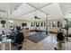 Bright fitness room with ceiling fan, tile flooring, and expansive windows overlooking greenery at 7405 N Via Camello Del Norte -- # 137, Scottsdale, AZ 85258