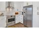 Contemporary kitchen featuring stainless steel appliances, subway tile backsplash, and sleek white cabinetry at 7405 N Via Camello Del Norte -- # 137, Scottsdale, AZ 85258