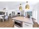 Bright, open kitchen featuring a modern island, gold pendant lights, and views of the living and dining areas at 7405 N Via Camello Del Norte -- # 137, Scottsdale, AZ 85258
