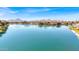 Panoramic view of a tranquil lake surrounded by beautiful homes and distant mountains at 7405 N Via Camello Del Norte -- # 137, Scottsdale, AZ 85258