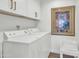Functional laundry room equipped with washer, dryer, and ample cabinet space for storage at 7405 N Via Camello Del Norte -- # 137, Scottsdale, AZ 85258