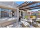 Charming patio with wicker seating, a pergola, and lush greenery, offering a tranquil outdoor space at 7405 N Via Camello Del Norte -- # 137, Scottsdale, AZ 85258