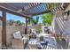 Inviting outdoor patio with comfortable seating, a grill, and a pergola for shade, perfect for entertaining at 7405 N Via Camello Del Norte -- # 137, Scottsdale, AZ 85258