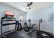 Finished basement set up as a home gym, complete with weight lifting equipment and a ceiling fan at 7438 E Glenn Moore Rd, Scottsdale, AZ 85255
