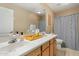Bathroom featuring dual sinks with laminate counters, light wood cabinets, and neutral colored walls at 7438 E Glenn Moore Rd, Scottsdale, AZ 85255