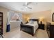 Cozy bedroom featuring dark wood furniture, neutral walls, and a ceiling fan at 7438 E Glenn Moore Rd, Scottsdale, AZ 85255