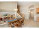 View of dining area with wooden table, chairs, and staircase leading to the second floor at 7438 E Glenn Moore Rd, Scottsdale, AZ 85255