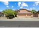 Inviting home featuring a three-car garage, desert landscaping, and a well-maintained exterior at 7438 E Glenn Moore Rd, Scottsdale, AZ 85255