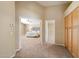 Hallway leading to a main bedroom with a ceiling fan and plush carpets at 7438 E Glenn Moore Rd, Scottsdale, AZ 85255