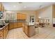 Spacious kitchen with granite countertops, an island, stainless steel appliances, and light wood cabinets at 7438 E Glenn Moore Rd, Scottsdale, AZ 85255