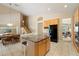 Open-concept kitchen with granite island, stainless fridge, and views to dining area and stairway at 7438 E Glenn Moore Rd, Scottsdale, AZ 85255