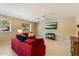 Comfortable living room with red sofas, flat-screen TV, and view to the garden at 7438 E Glenn Moore Rd, Scottsdale, AZ 85255