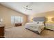 Spacious primary bedroom with a vaulted ceiling, a ceiling fan and a large window at 7438 E Glenn Moore Rd, Scottsdale, AZ 85255