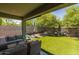 Inviting covered patio with comfortable seating and a view of the well manicured backyard at 7732 S 23Rd St, Phoenix, AZ 85042