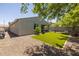 Well-maintained backyard with gravel, bordered artificial turf, and block wall at 7732 S 23Rd St, Phoenix, AZ 85042
