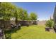 Expansive backyard featuring artificial turf, mature trees, and privacy fencing at 7732 S 23Rd St, Phoenix, AZ 85042