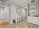Bright hallway featuring wood-look flooring, white cabinets, and decorative accents at 7732 S 23Rd St, Phoenix, AZ 85042