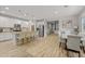 Spacious kitchen with white cabinetry, stainless appliances, an island with bar seating, and wood look floors at 7732 S 23Rd St, Phoenix, AZ 85042
