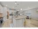 Open-concept kitchen flowing into dining area; features include a center island, stainless appliances, and pantry storage at 7732 S 23Rd St, Phoenix, AZ 85042