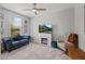 Comfortable living room with tufted sofa, fireplace, and neutral decor at 7732 S 23Rd St, Phoenix, AZ 85042