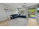 Bright and inviting living room with a large plush sofa, neutral walls, and sliding doors to the backyard at 7732 S 23Rd St, Phoenix, AZ 85042