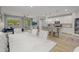 Open-concept living space features a modern kitchen, dining area, and comfortable seating area with a view to the outside at 7732 S 23Rd St, Phoenix, AZ 85042