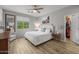 Bright main bedroom with wood-look floors, a ceiling fan, and a walk-in closet at 7732 S 23Rd St, Phoenix, AZ 85042