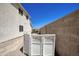 Exterior shot shows backyard with a privacy fence, exterior of home, and desert landscaping at 8228 S Stephanie Ln, Tempe, AZ 85284