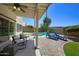 Inviting covered patio overlooks the pool and lush backyard with lounge chairs at 8228 S Stephanie Ln, Tempe, AZ 85284