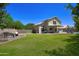 Expansive backyard includes manicured lawn, desert landscaping, fire pit, and a pool at 8228 S Stephanie Ln, Tempe, AZ 85284