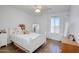 Cozy bedroom with wood floors, a white bed with stuffed animals, and natural light at 8228 S Stephanie Ln, Tempe, AZ 85284