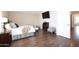Comfortable bedroom with hardwood floors, a cozy bed, and ample natural light entering from covered windows at 8228 S Stephanie Ln, Tempe, AZ 85284