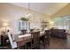 Charming dining room featuring wood floors, vaulted ceilings, and modern light fixture at 8228 S Stephanie Ln, Tempe, AZ 85284