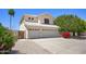Charming two-story home with a three car garage, desert landscaping, and large driveway at 8228 S Stephanie Ln, Tempe, AZ 85284