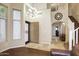 A spacious home foyer with tile flooring, high ceilings, and a staircase leading to the second floor at 8228 S Stephanie Ln, Tempe, AZ 85284