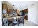 A kitchen with granite countertops, dark cabinets, and modern appliances creates a sleek and stylish space at 8228 S Stephanie Ln, Tempe, AZ 85284