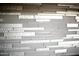 Striking backsplash made up of various tile styles and textures adds depth to the room at 8228 S Stephanie Ln, Tempe, AZ 85284