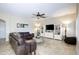 Spacious living room featuring tile floors, ceiling fan, and modern built-in shelving at 8228 S Stephanie Ln, Tempe, AZ 85284