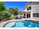 Sparkling pool with seating area, patio and a grassy yard, surrounded by desert landscaping at 8228 S Stephanie Ln, Tempe, AZ 85284