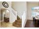The staircase features wood treads, white risers and a view of the living area to the right at 8228 S Stephanie Ln, Tempe, AZ 85284