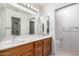 Well-lit bathroom with a double sink vanity, large mirror, and separate toilet area at 8255 E Kiva Ave # 420, Mesa, AZ 85209