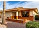 Inviting single-story home with a two-car garage, desert landscaping, and appealing front entrance with brick accents at 8255 E Kiva Ave # 420, Mesa, AZ 85209