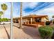 Charming single-story home featuring a two-car garage, desert landscaping, and inviting front with brick details at 8255 E Kiva Ave # 420, Mesa, AZ 85209