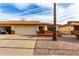 Charming single-story home with a two-car garage, desert landscaping, and a well-maintained front yard at 8255 E Kiva Ave # 420, Mesa, AZ 85209