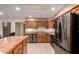 Spacious kitchen with stainless steel appliances, wooden cabinets, tile floors, and a wooden breakfast bar island at 8255 E Kiva Ave # 420, Mesa, AZ 85209