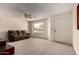 Bright living room with neutral carpet, ceiling fan, and a view of the well-kept front yard through the window at 8255 E Kiva Ave # 420, Mesa, AZ 85209