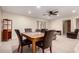 Open-concept living area with dining table, neutral carpet, and access to other rooms at 8255 E Kiva Ave # 420, Mesa, AZ 85209